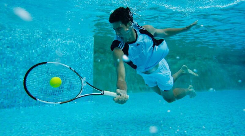 a man plays tennis in a pool