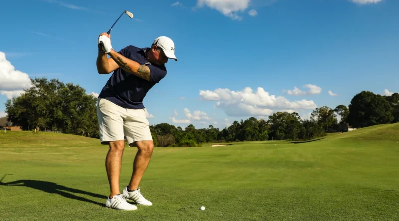 A man plays golf on a golf course